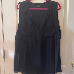 Sleeveless black blouse. It is see through so you would need a cami under it